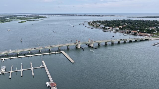 Aerial view of the Bridge of Lions spanning the Matanzas River with boats in the marina and the historic city of St. Augustine in the background, St. Augustine, Florida, United States.