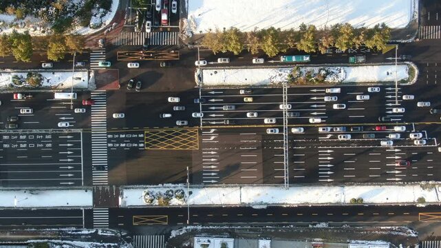 Aerial View of Snowy City Intersection with Traffic in Winter