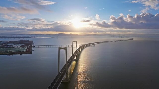 Aerial View of Hong Kong-Zhuhai-Macau Bridge at Sunset with Sun Reflection on Sea