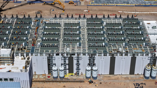 Aerial view of a large industrial facility featuring numerous rooftop HVAC units, cooling systems, and storage tanks in Clark, Nevada, United States.