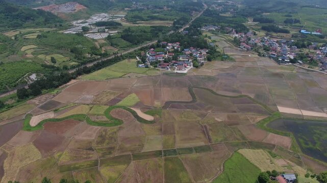 Aerial View of Terraced Rice Paddies and Rural Village in Countryside