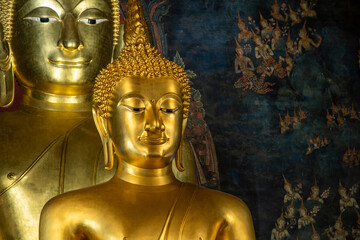 A close-up horizontal shot of the sacred golden Phra Phuttha Chinnasi Buddha statue inside Wat Bowonniwet Vihara temple. © Jirakon