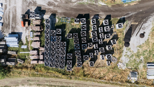 Aerial view of TASYAPI construction site with organized rows of concrete structural elements and stacks of building materials in Kuzmin, Vojvodina, Serbia.