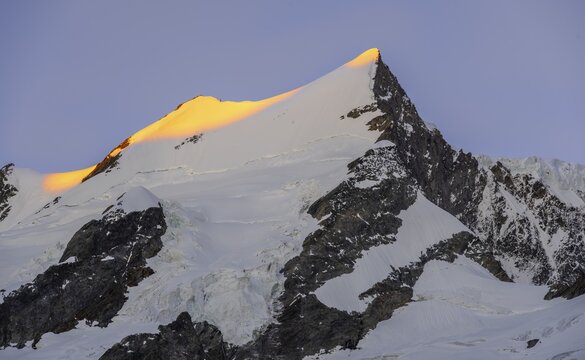 Alpenglow, first sunlight, summit of the Gro&szlig;er Fiescherhorn, Bernese Oberland, Switzerland