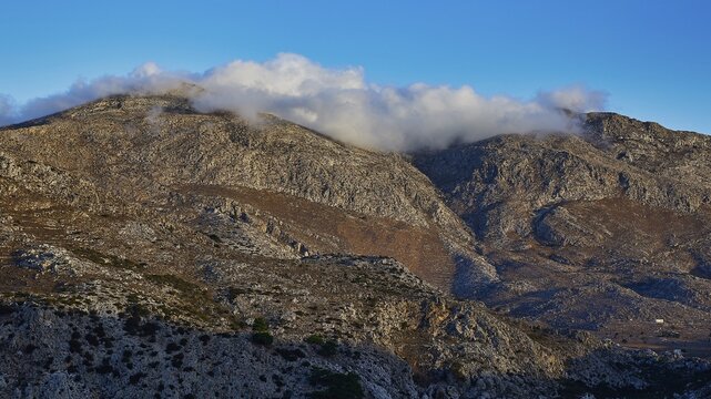 Mountain landscape with clouds floating on the peaks, under a blue sky, Morning mountain landscape, Lastos, Island centre, Karpathos, Dodecanese, Greek Islands, Greece
