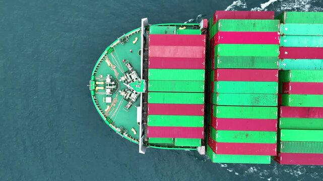 Aerial top view of cargo ship with contrail in the ocean sea ship carrying container and running from container international port smart freight shipping by ship service