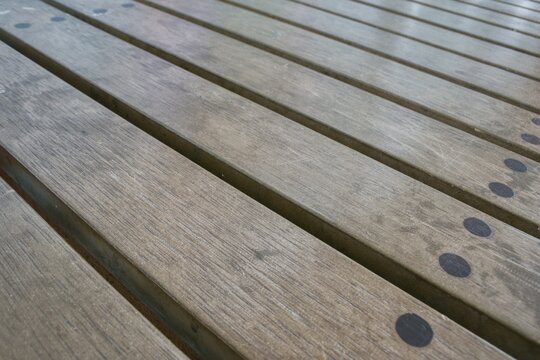 Perspective view of parallel wooden slats pattern on modern park bench surface