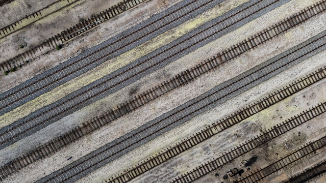 Aerial view of parallel railway tracks stretching across the industrial landscape in Gdansk, Poland.