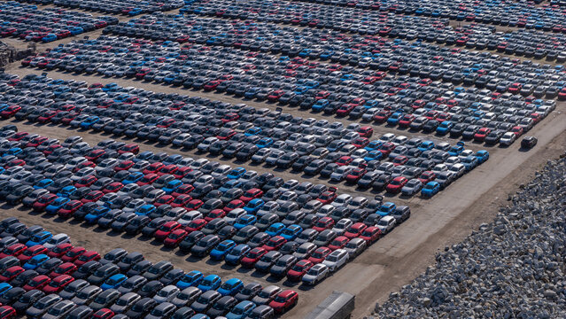 Aerial view of a vast car storage terminal filled with rows of new vehicles parked at the port in Gdansk, Poland.