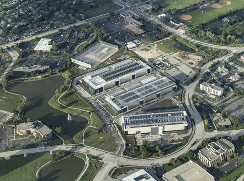 Aerial view of a large data center complex surrounded by landscaped ponds, parking lots, and office buildings in Chicago, Illinois, United States.
