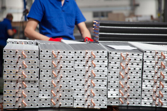 These are copper-tube, aluminum-fin coils (condenser or evaporator blocks) used in refrigeration and air conditioning systems.