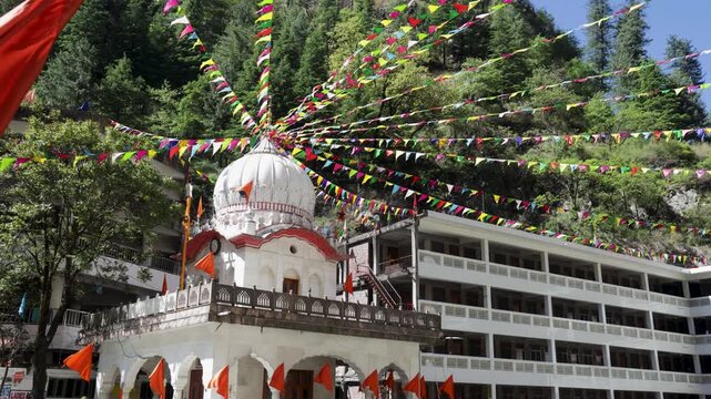 Manikaran Sahib Gurudwara Complex With Ornate Dome and Colorful Flags