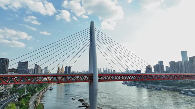 Aerial view of a modern cable-stayed bridge over a river in Chongqing, China with city skyline