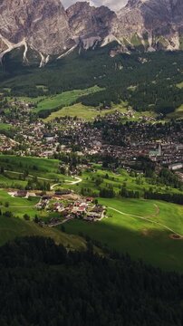 Cortina d&rsquo;Ampezzo, Province of Belluno, Veneto, Italy - A Breathtaking View of a Beautiful Town Surrounded by Alpine Meadows and the Majestic Dolomite Mountains - Vertical Shot