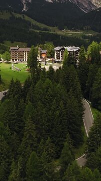 Cortina d&rsquo;Ampezzo, Province of Belluno, Veneto, Italy - Elegant Mountain Resorts Surrounded by Lush Forests, Green Meadows, and the Majestic Dolomites - Vertical Shot