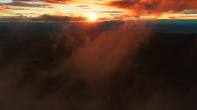 Golden sunrise glowing through dense morning mist over the mountains near Popocatepetl in Izta Popo Zoquiapan National Park, Mexico.
