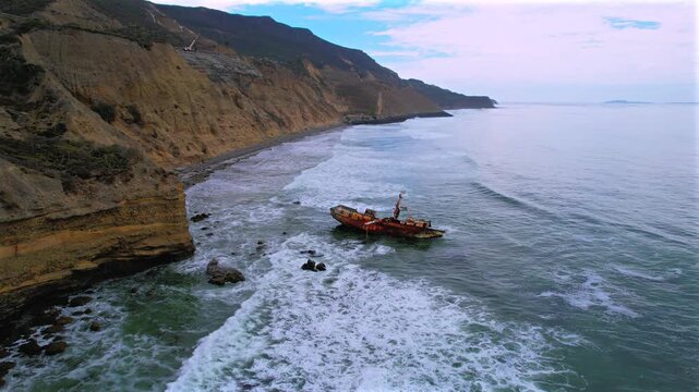 VICMAR shipwreck reveals the rugged Baja California coast and Highway 1D between Tijuana and Ensenada, Mexico. Aerial pullback.