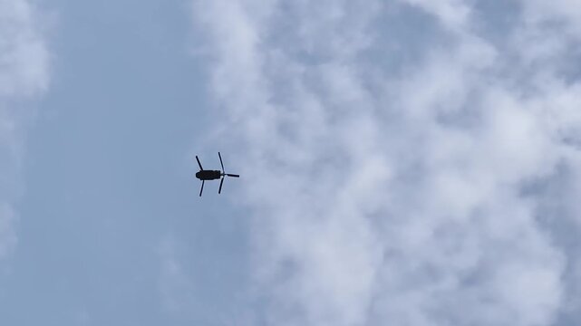 Helicopter flies overhead to assist in forest fire response effort