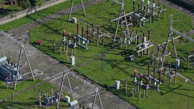 Electrical power substation with high voltage transformers and insulators aerial view
