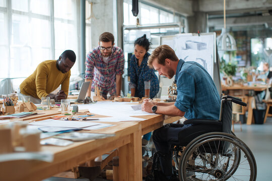 Inclusive Team Of Industrial Designers Collaborating In Bright Accessible Studio
