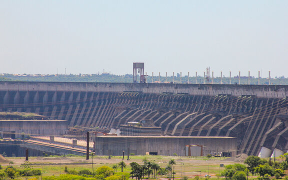 View of the massive concrete structure of the Itaipu Dam hydroelectric power plant with its industrial architecture and surrounding landscape in Itaipulandia, Parana, Brazil.