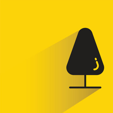 pine tree with shadow on yellow background