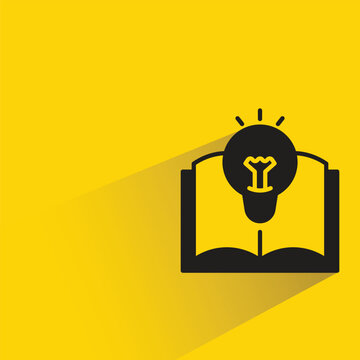 light bulb on book icon with shadow on yellow background