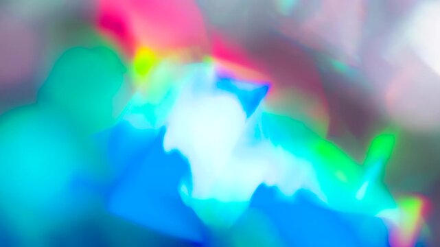 Prismatic Decomposition of Solar Light. Light passes through the facets of a slowly rotating faceted crystal, creating repeating sparkling reflections and iridescent colors