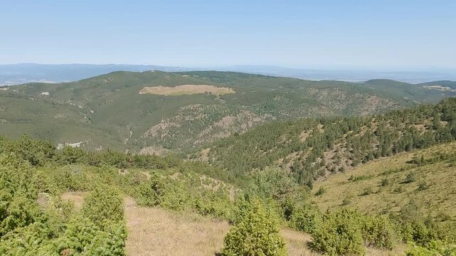 Panning shot of the nature landscape from Ljukten, the highest peak of mountain Goc, Serbia, on a clear sunny day