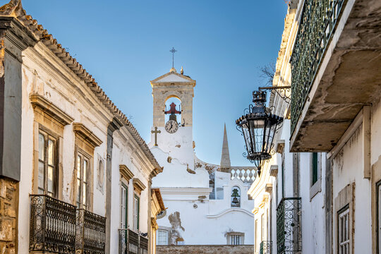 Rua do Municipio in Faro Old Town, leading toward the Arco da Vila, the monumental neoclassical gateway to the historic walled city, Algarve, Portugal