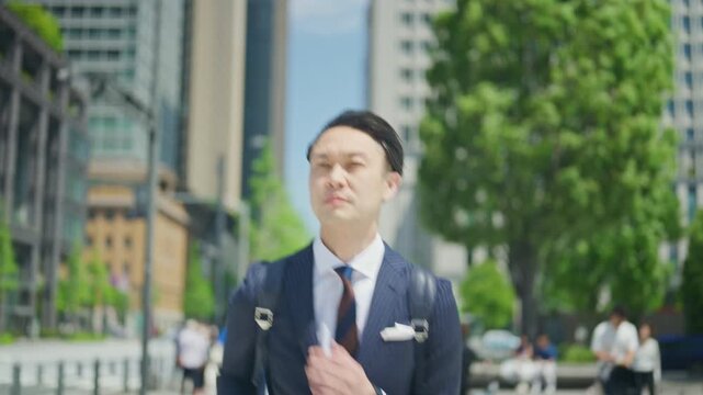 Businessman pausing to look at the city while walking to the office