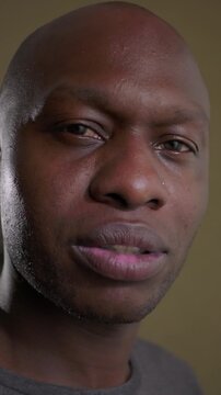 African American man gazing directly into lens with calm composure expressing genuine authenticity mature introspection and grounded domestic presence