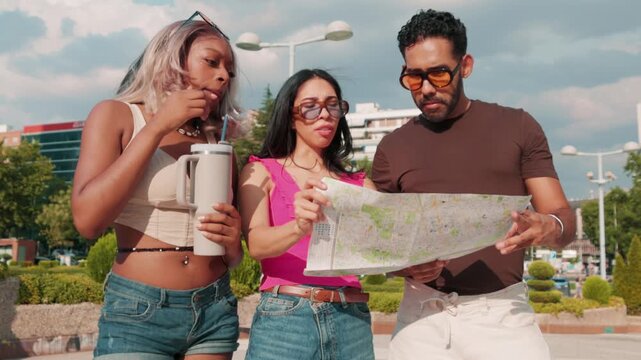 Diverse group of young professionals consulting a city map outdoors
