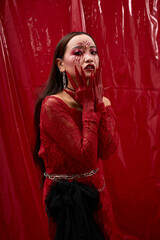 Naklejka premium Young Asian woman embodies dark queen vibes in Halloween glamour