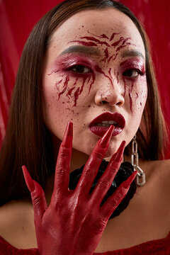 Vampire queen with bloody face and dark elegance for Halloween celebration
