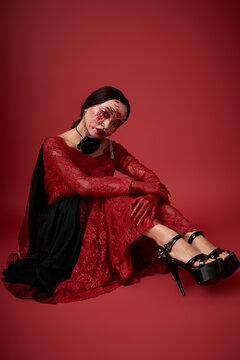 Young Asian woman embodies dark queen with horror-inspired Halloween look