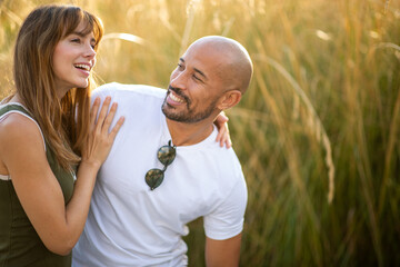 Fototapeta premium Happy couple enjoying romantic moment outdoors at sunset