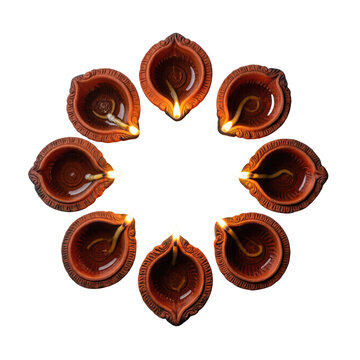 Eight lit clay diyas arranged in a circle, isolated on transparent background