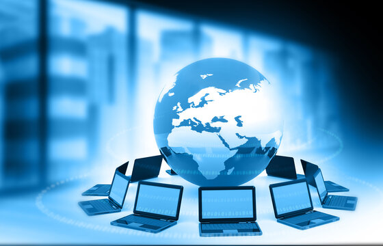 Modern laptop computer with a glowing digital world globe on a professional corporate office background.