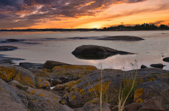 Dramatic Sunset Over Rocky Skerry Coast by Calm Sea. In Sweden, Darvik.