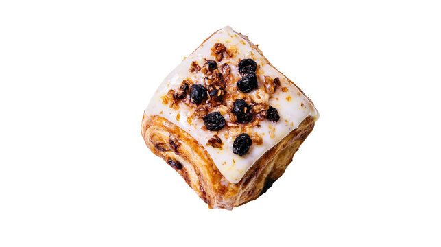 Isolated delicious sweet Danish pastry with creamy icing, dried fruits, and crunchy nuts.