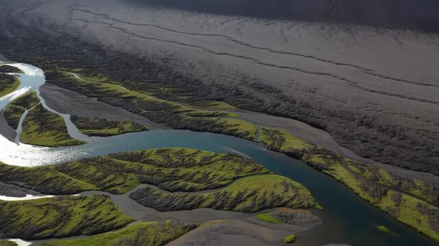 Braided river flows through moss-covered volcanic wilderness terrain. Nature documentaries, environmental education, and river ecology campaigns.