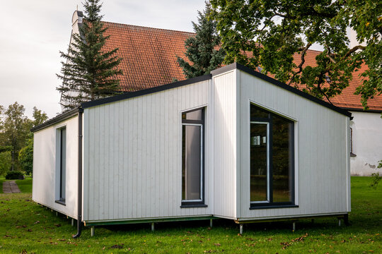 Modern White Modular Building in a Green Garden Setting