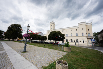 Historic town hall and city square in Radom Poland with dramatic cloudy sky and landscaped promenades © AS Photo Family
