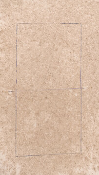 Aerial view of a textured beige surface featuring a hand-drawn rectangular outline in Riga, Latvia.