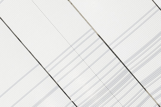Aerial view of a white corrugated metal roof with repeating diagonal lines and structural seams in Taiwan.