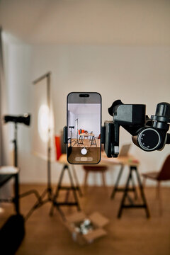 Smartphone mounted on a tripod recording video in a creative studio setup