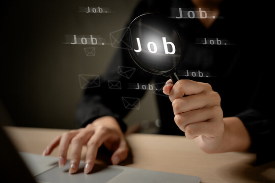 Job search and recruitment concept with a person using laptop and magnifying glass to explore employment opportunities online. Career, hiring, employment, recruitment, vacancy.