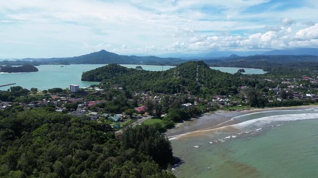 Calang, Indonesia : Aerial drone footage of wave breaks into the beach in Calang, coastal town in Aceh Jaya of Sumatera, Indonesia. Taken with orbit motion showing ocean view and mountain in the backg
