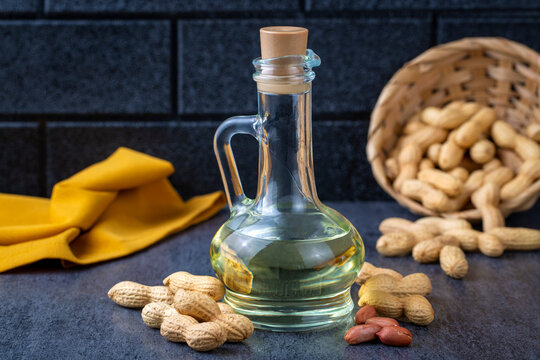 Peanut oil in glass bottle and peanuts